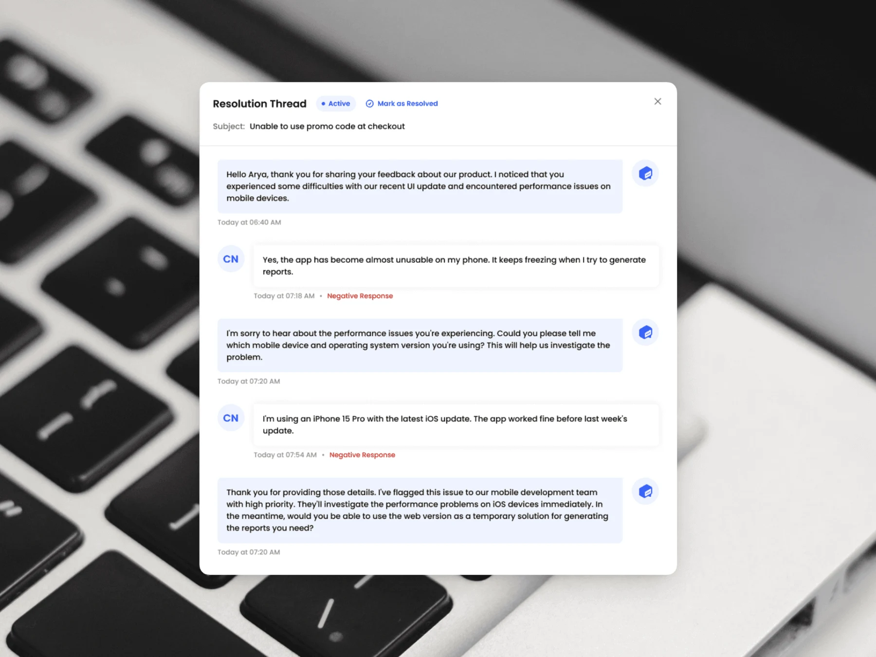 Screenshot of a FeedbackRobot AI-powered resolution thread showing a back-and-forth conversation between a customer and an automated response, overlaid on a photo of a keyboard.