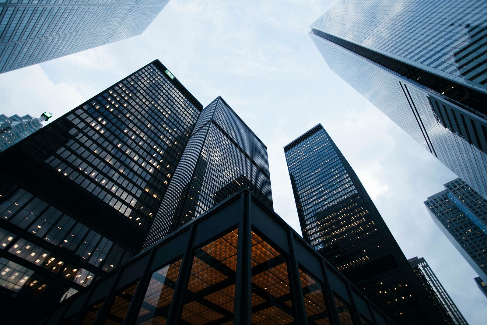 Low angle photo of city high rise buildings during daytime.